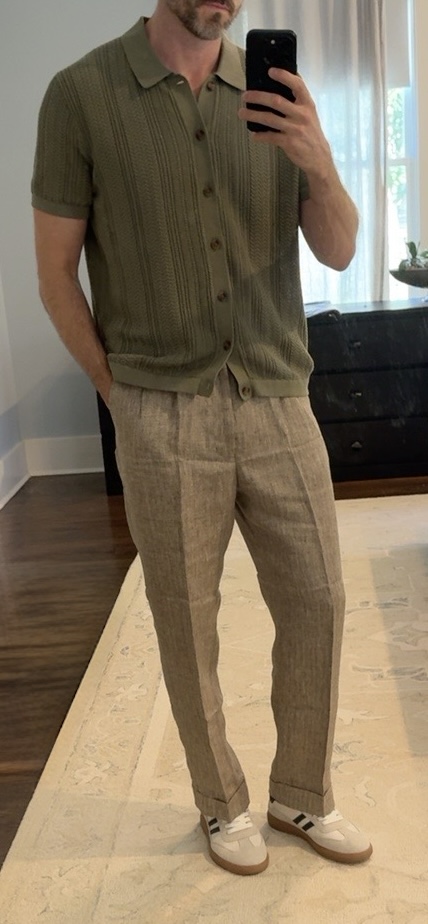Client mirror photo wearing an olive knit button shirt, tan linen trousers, and white sneakers